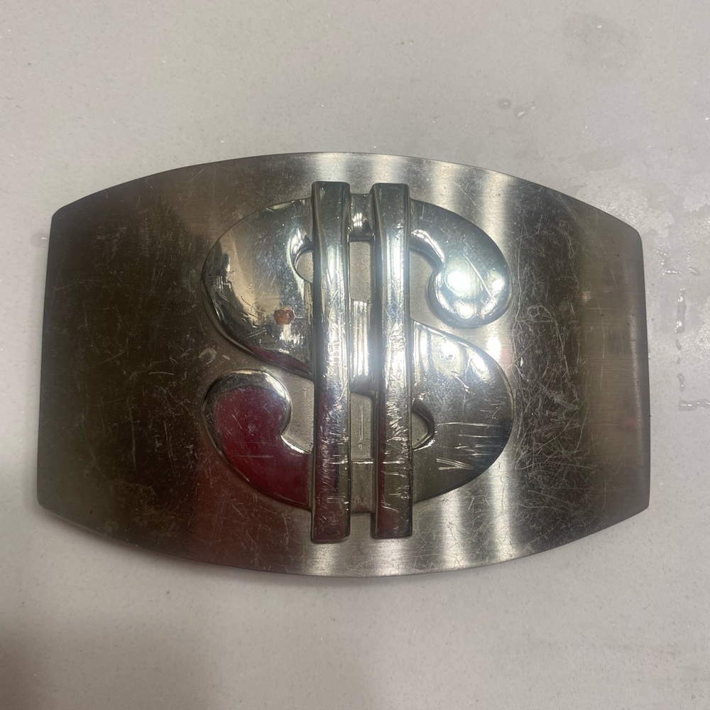 Dollar sign belt buckle